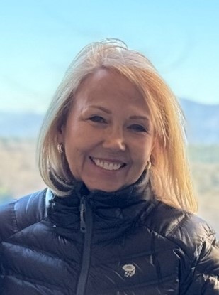 Debbie Bankert photographed outdoors, the Blue Ridge mountains behind her.